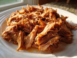 Close-up of tender, shredded pork meat, ready to be served with pork and sauerkraut.