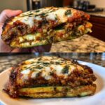 Close-up of a thick slice of zucchini lasagna showing layers of meat sauce, cheese, and zucchini noodles.